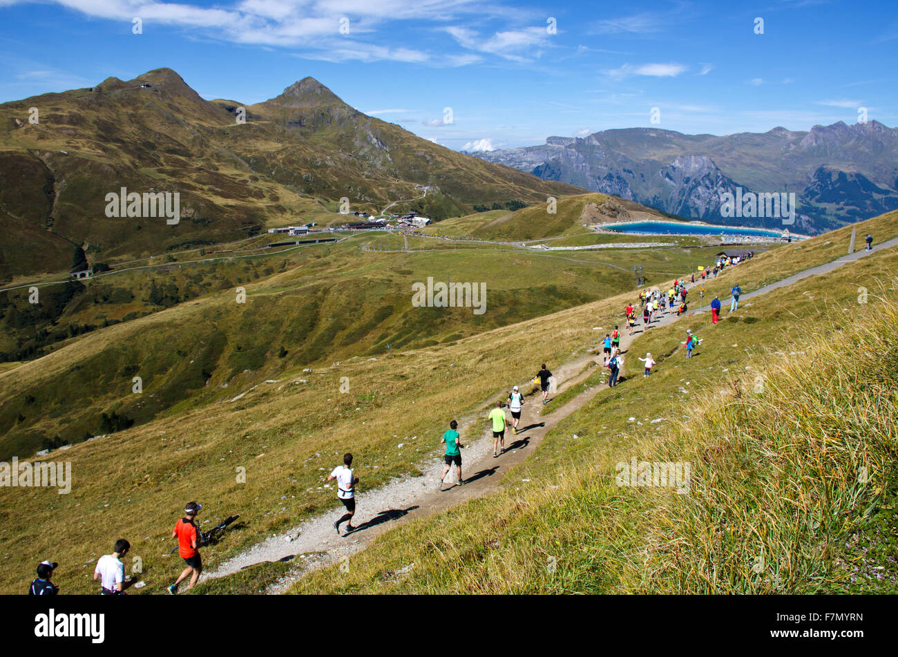 Runners approaching Kleine Scheidegg finish line  during 2015 Jungfrau Mountain Marathon race from interlaken to Kleine Scheideg Stock Photo
