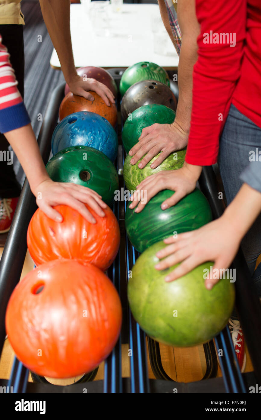 players hands and ball return system in bowling Stock Photo