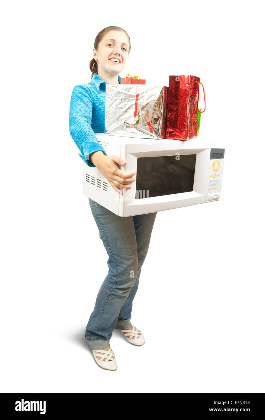 Girl in blue with microwave  and present boxes. Isolated over white Stock Photo