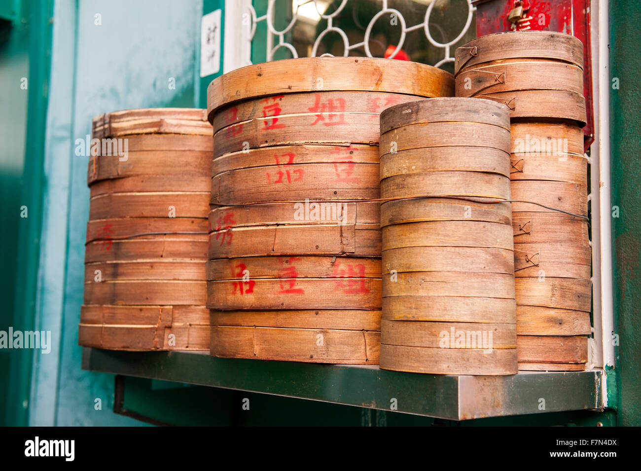 Stack of bamboo Chinese cooking steam baskets on shelf Stock Photo