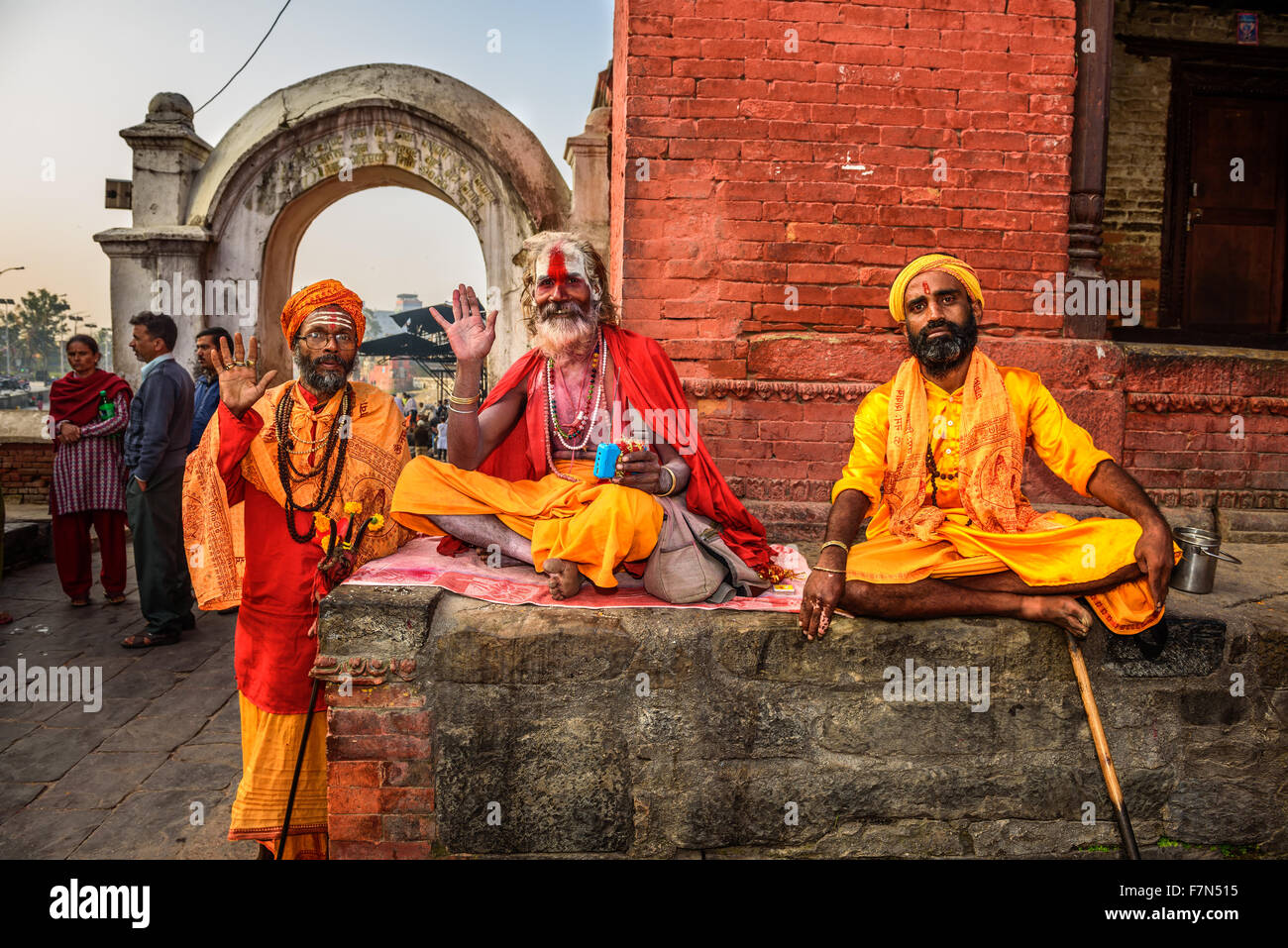 Three Shaiva sadhus (holy men) in traditional clothing in ancient Pashupatinath Temple Stock Photo