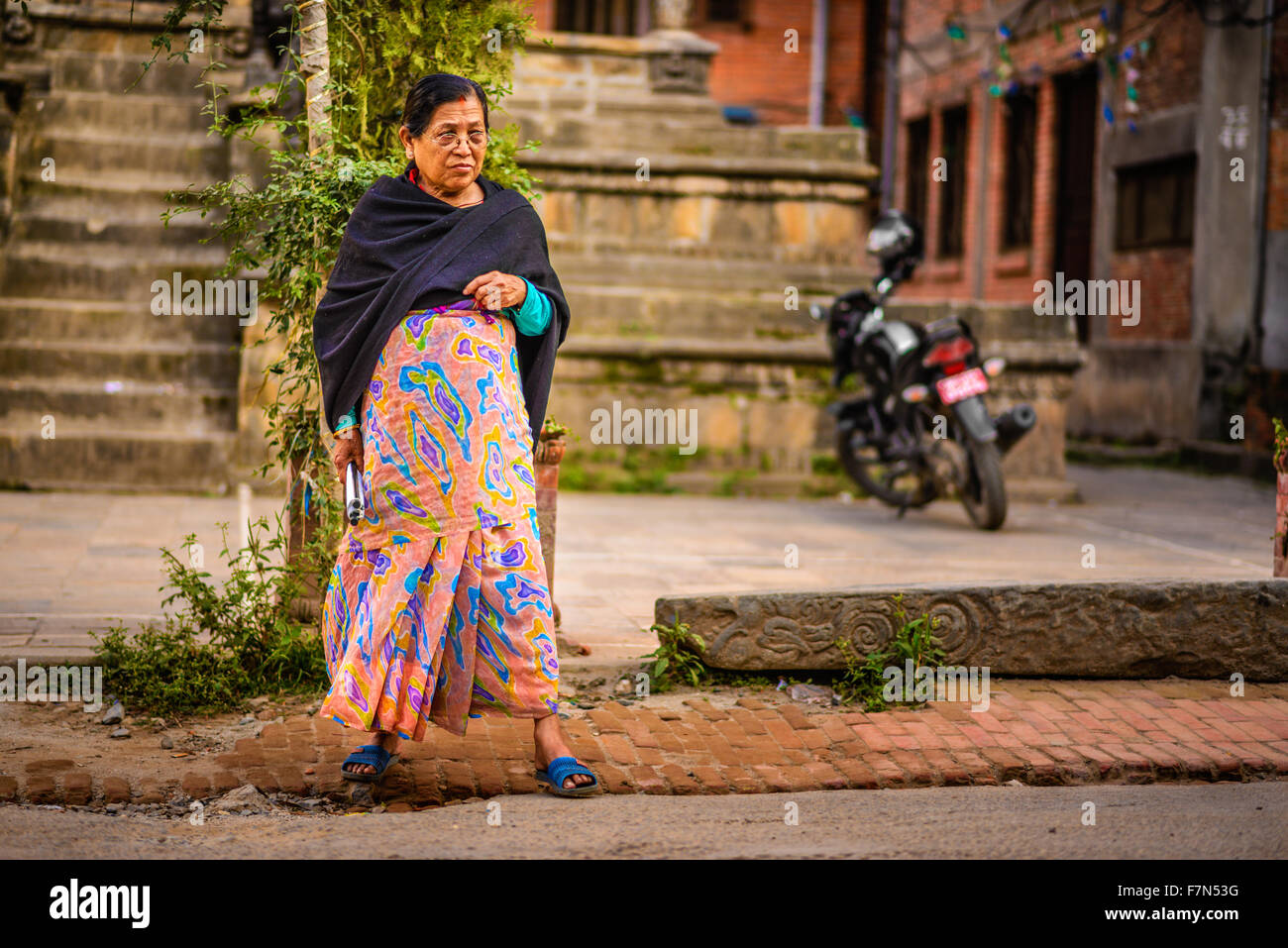 Old nepalese lady walking in Kathmandu Stock Photo