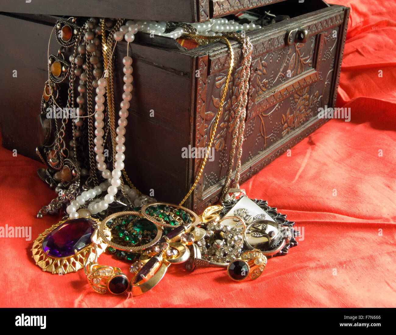 Wooden treasure chest with valuables in red Stock Photo Alamy