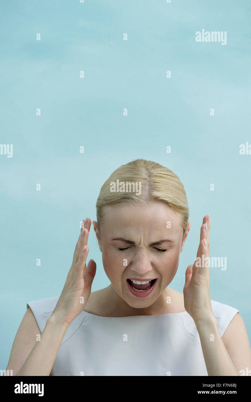 Woman shouting with eyes closed Stock Photo