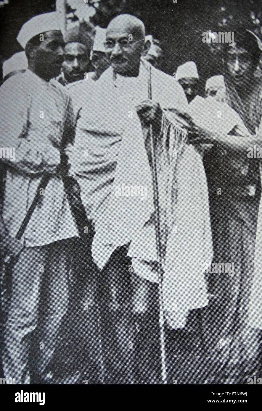 Mahatma Gandhi, Indian mystic and political leader, with some of his followers. 1930 Stock Photo