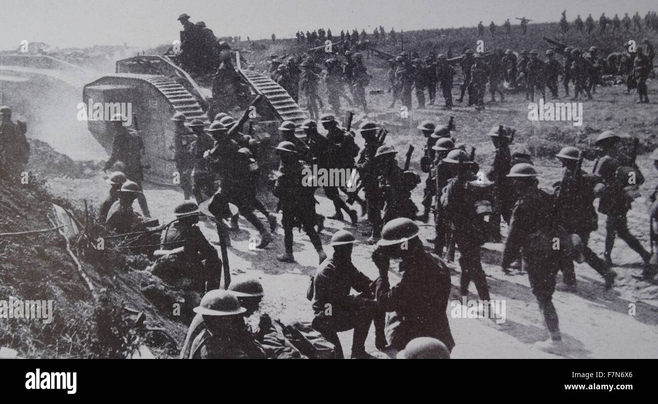 The tank, a British invention, was first used in the 1914-18 war in 1916 to end the deadlock of trench warfare. These Mark V tanks, together with infantry move forward at Grevilliers in August 1918. Stock Photo