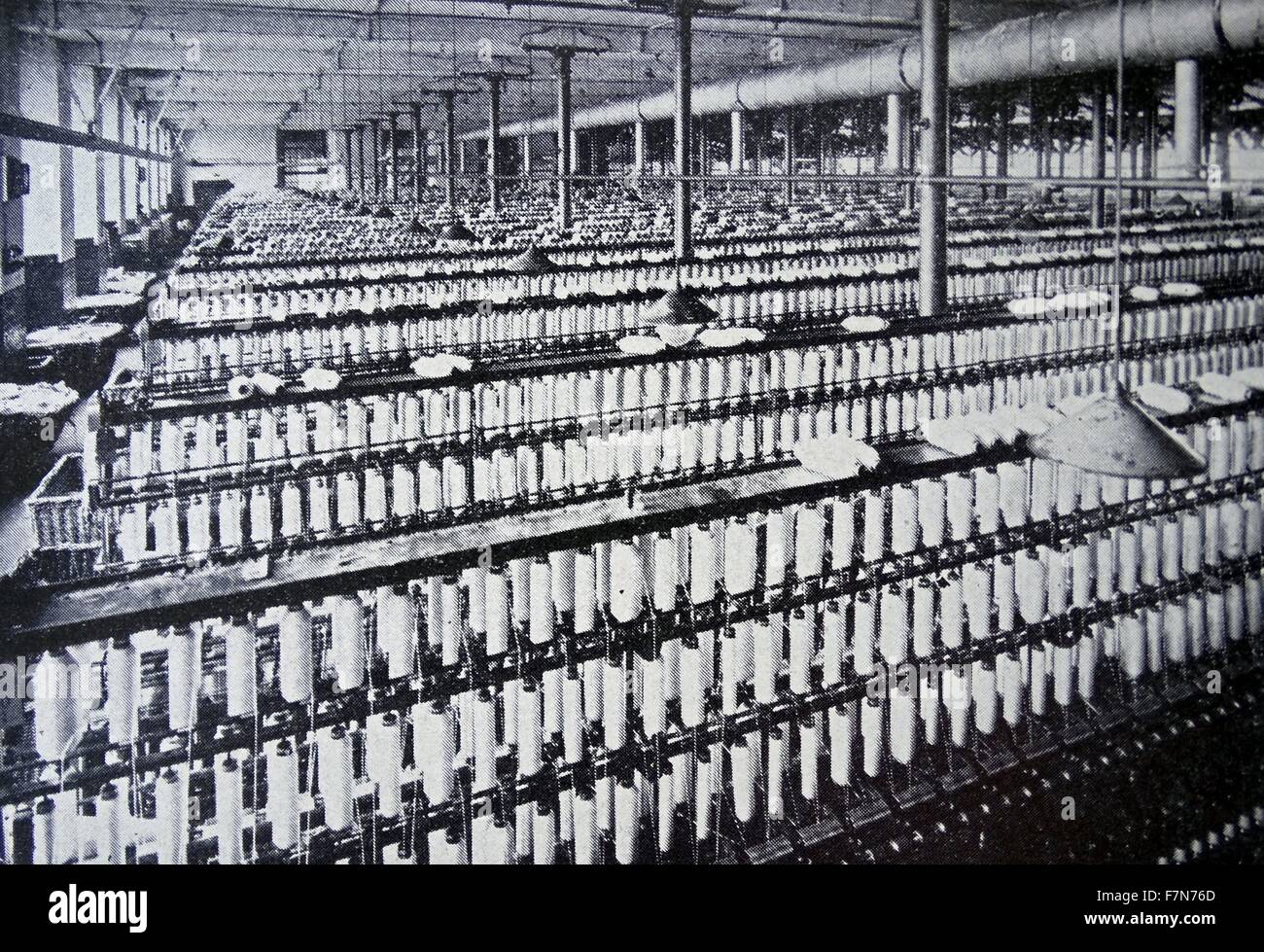 The spinning-mill of a large, english,  cotton factory.  This complicated machinery with a very  large output can be looked after by a relatively small number of employees. 1938 Stock Photo
