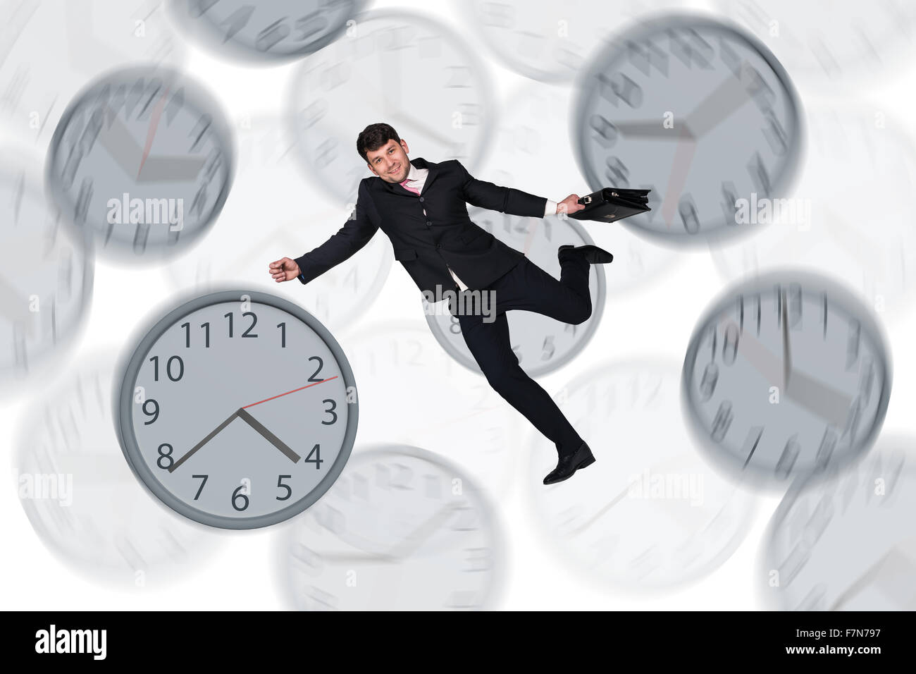 Businessman running late with among big clocks Stock Photo