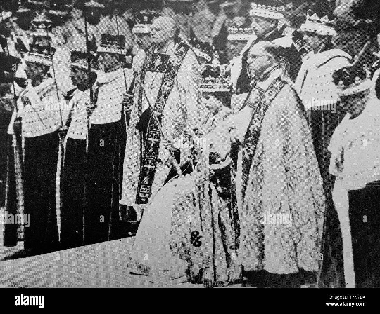 H.M. the Queen wearing St. Edward's Crown and holding the Royal Sceptre and the Rod of Equity, waits to receive the homage of her peers after her Coronation. Stock Photo