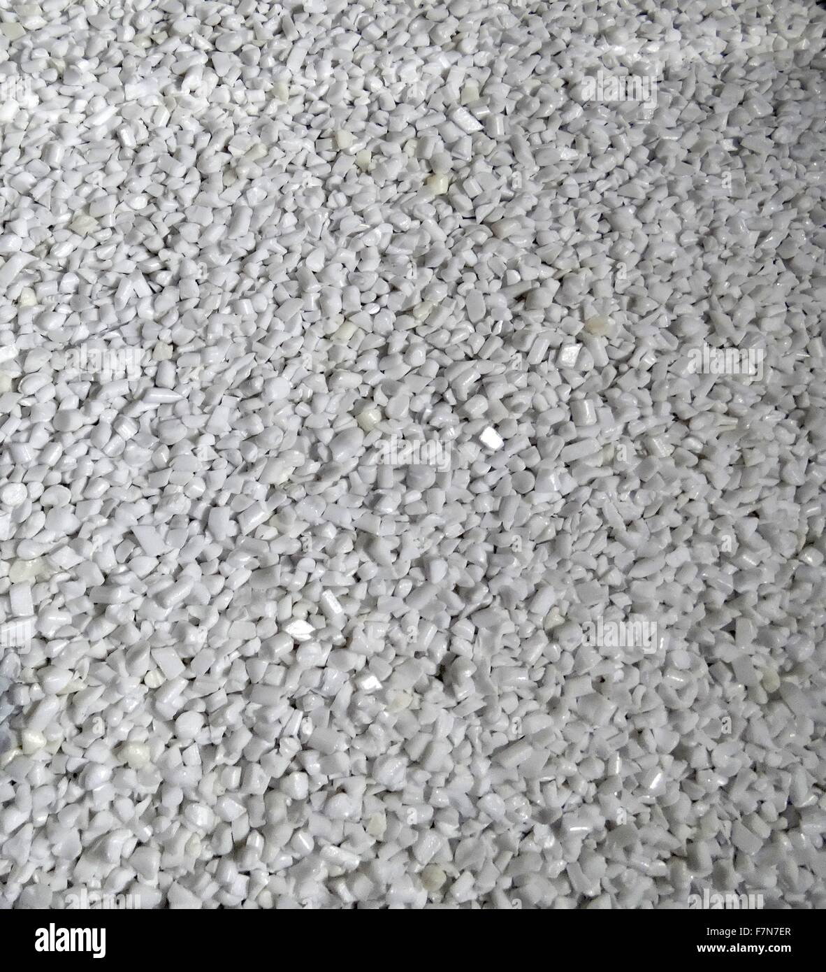 Bottles chopped into pellets. Polyethylene terephthalate  PET, PETE,  is a thermoplastic polymer resin of the polyester family and is used in synthetic fibers; beverage, food and other liquid container Stock Photo