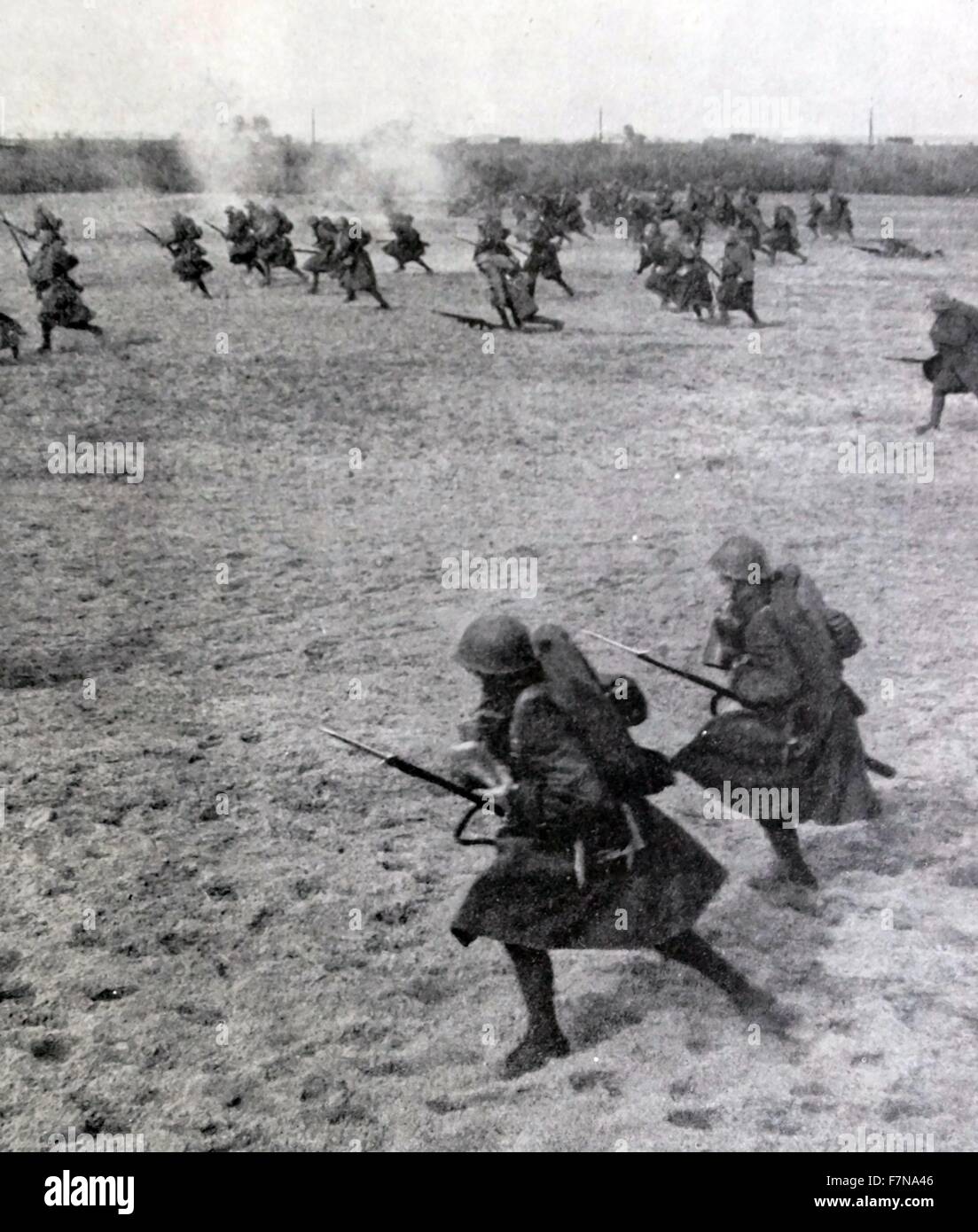 Photograph of Polish soldiers charging into battle. In addition to carrying a rifle they would also carry a gas mask and a steel helmet. Dated 1913 Stock Photo