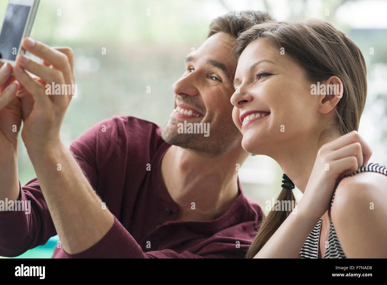 Couple posing for a selfie with a smartphone Stock Photo