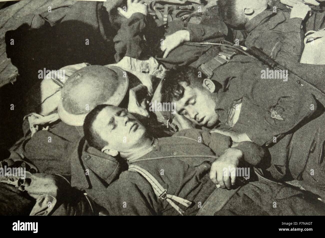 Photograph of soldiers asleep upon one another on the deck of ship homebound. Dated 1945 Stock Photo