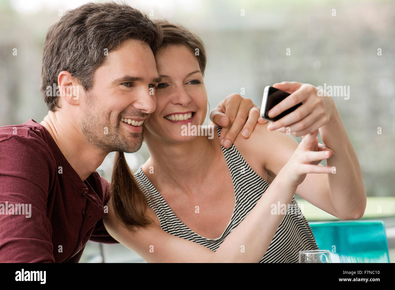 Couple posing for smartphone selfie Stock Photo