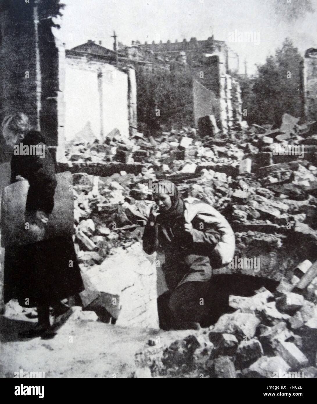 Photograph of women emerging from a shelter after an announcement that the Siege in Russia is ended. Dated 1942 Stock Photo