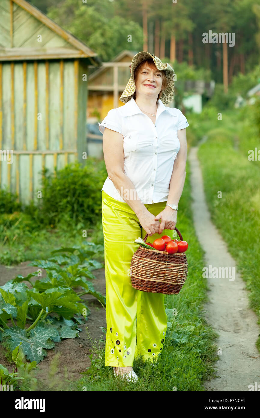 Happy mature woman with vegetables harvest Stock Photo - Alamy