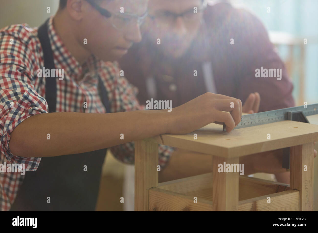 Focused carpenters measuring wood with ruler in Stock Photo Alamy