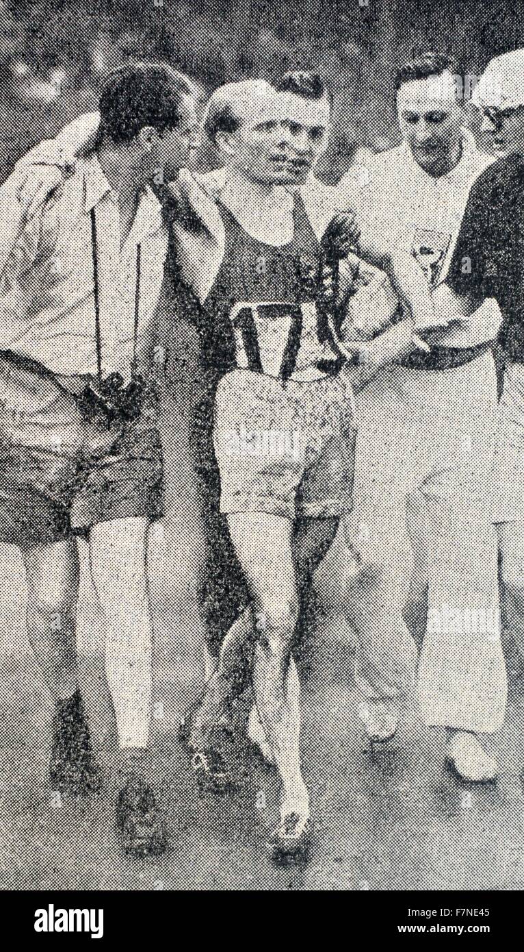 Gaston Reiff (1921-1992) (Belgium) assisted off the track by admirers after beating Emil Zatopek in a desperate race for the 5,000 metres.  He won the 1948 Olympic title in the 5,000 m. Stock Photo