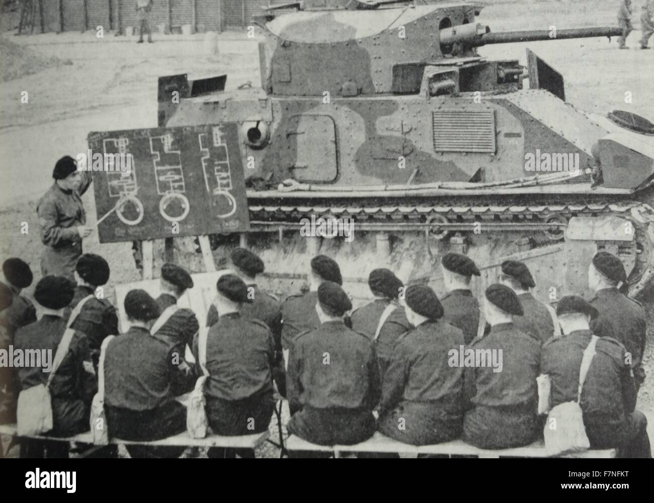 Tank training in England during World War Two 1940. The tank which made its first appearance during the Battle of the Somme.  Here men of the Tank Corps are being instructed in engineering theory - a practical demonstration will afterwards be given on the tank itself. Stock Photo