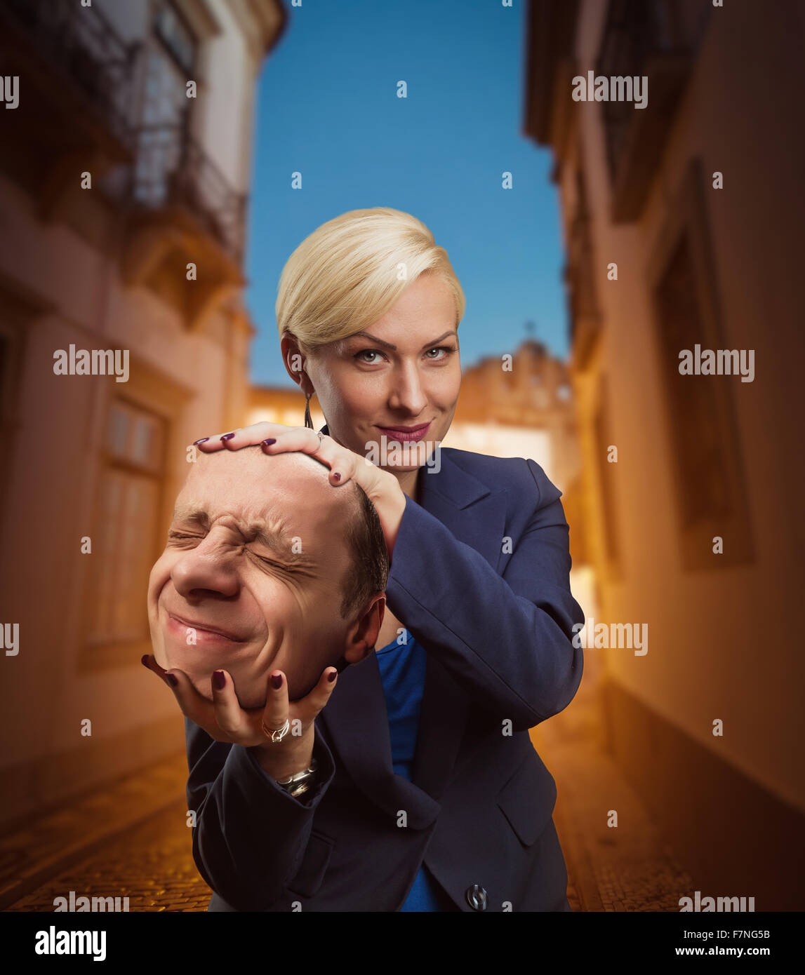 Woman with man's head in her hand Stock Photo