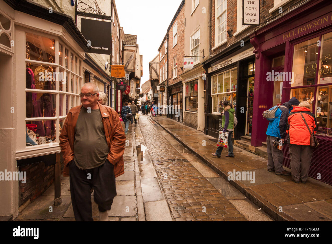 Looking along The Shambles, a narrow cobbled street in York,North Yorkshire,England busy with shoppers and tourists Stock Photo