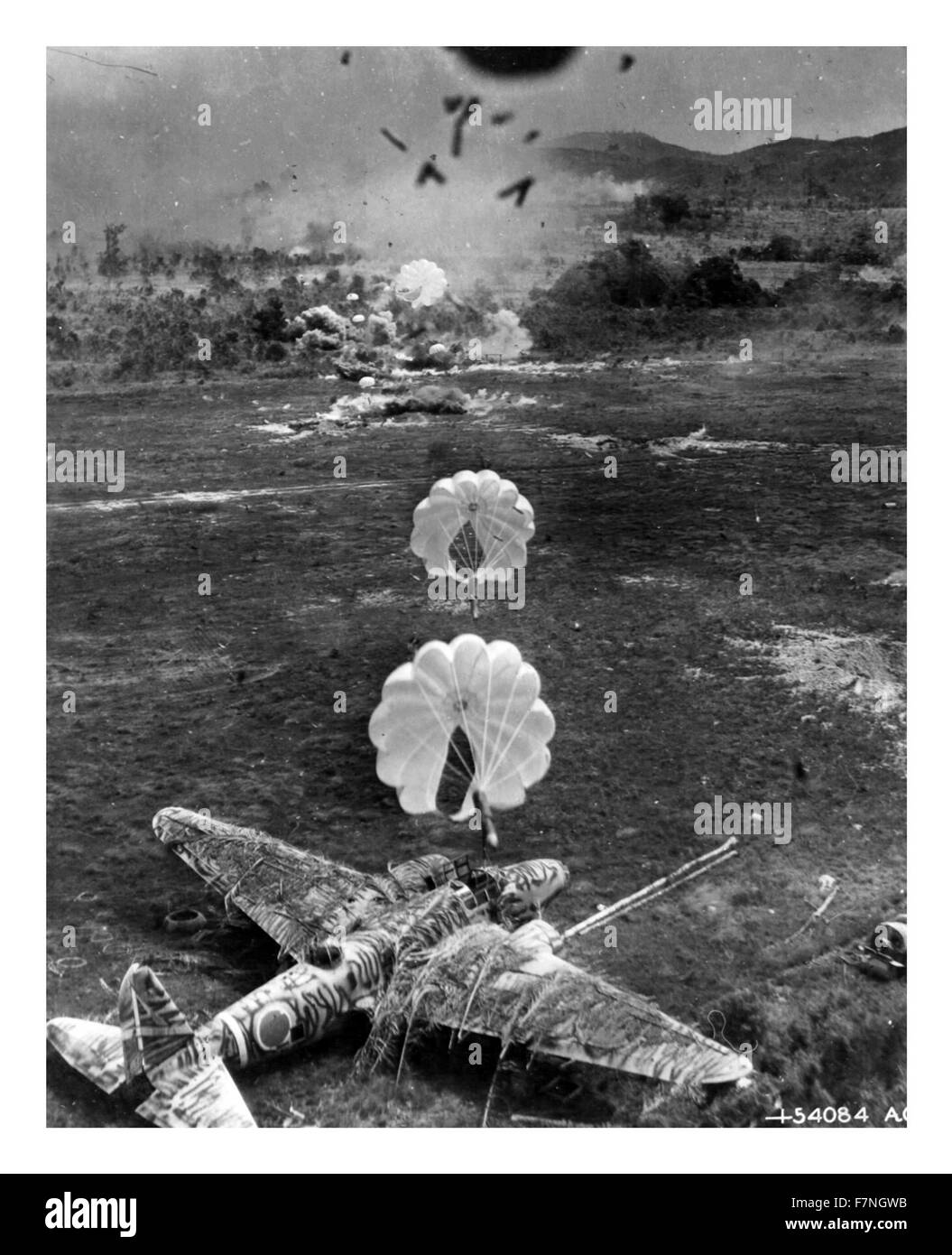 Photograph of camouflaged Japanese Mitsubishi Ki-21-IIb bomber seconds before its destruction by parafrag bombs dropped by a U.S. Army Air Force Douglas A-20 Havoc. Dated 1943 Stock Photo