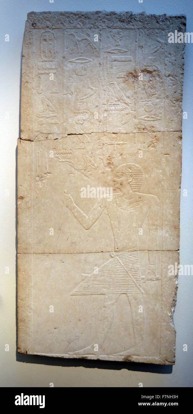 Limestone stela with an Egyptian servant depicted below hieroglyphs. Dated 1400 B.C. Stock Photo