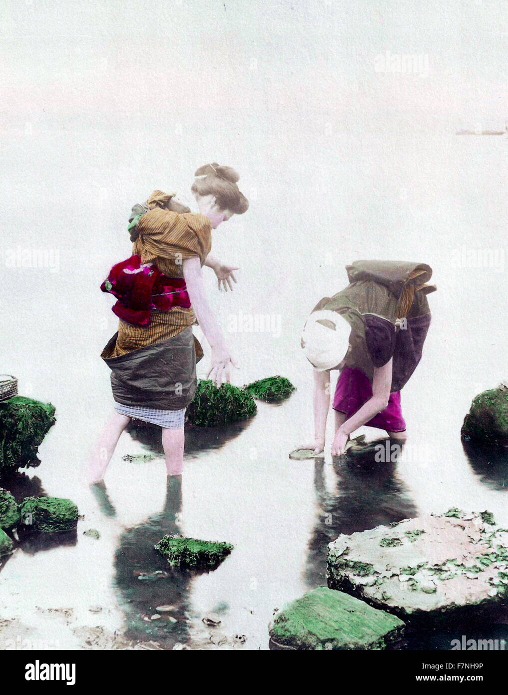 Hand-coloured photograph of women in river, photographed by Ogawa Kazumasa (1860-1929) Japanese photographer and pioneer in photomechanical printing during the Meiji Era. Dated 1890 Stock Photo