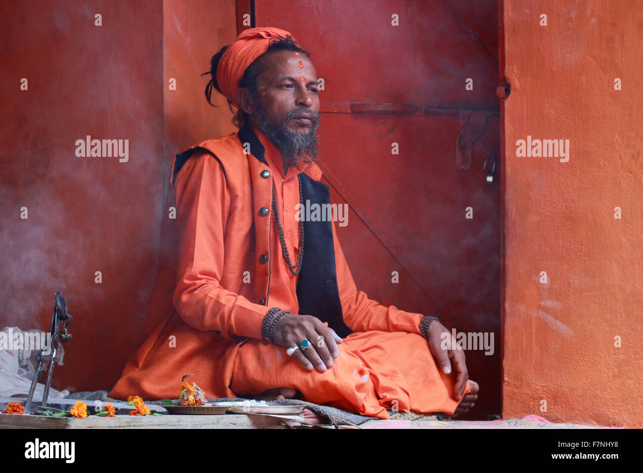 Sadhu in saffron colored clothing Kumbh Mela, Nasik, Maharashtra, India