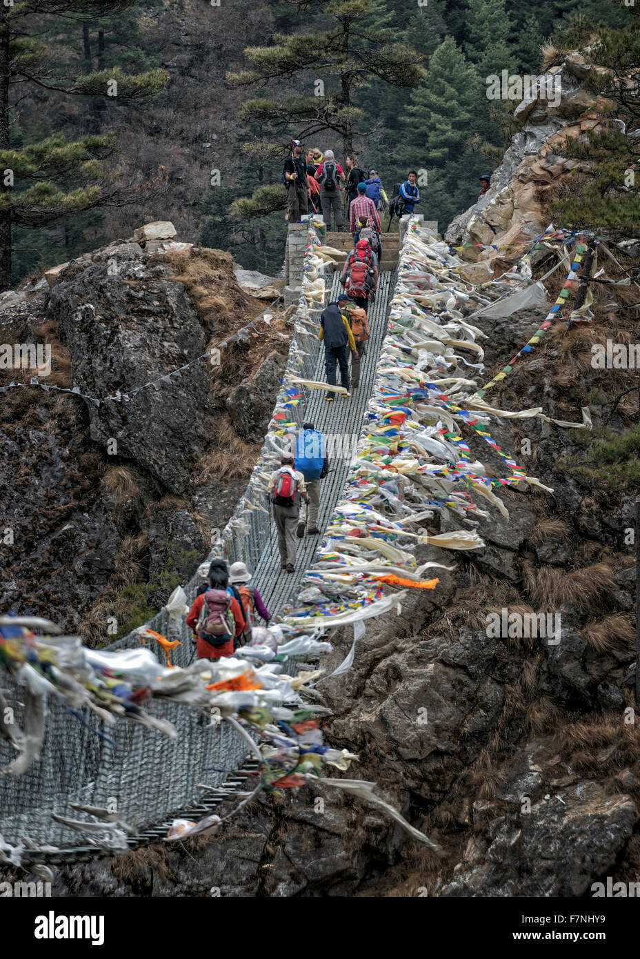 Nepal, Himalaya, Khumbu, trekkers crossing a bridge Stock Photo