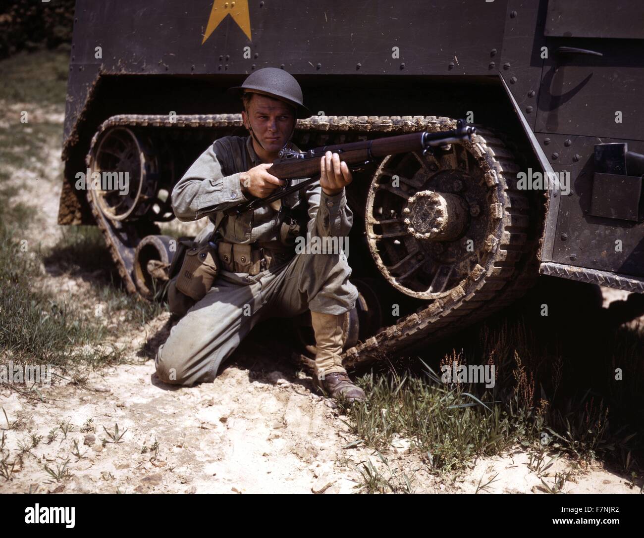 A young soldier of the armored forces holds and sights his Garand rifle like an old timer, Fort Knox, Ky. He likes the piece for its fine firing qualities and its rugged, dependable mechanism 1943 World War Two Stock Photo