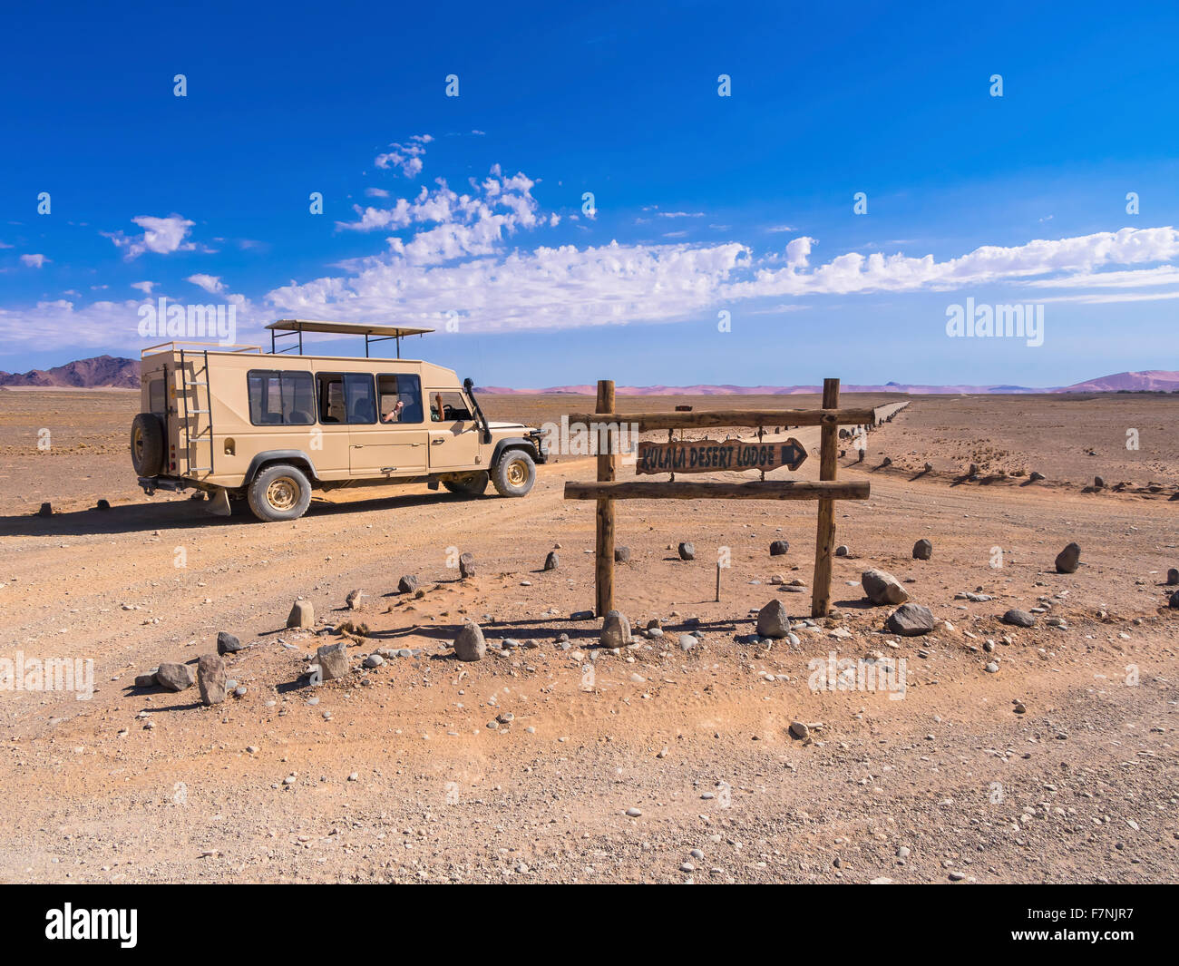 Namibia, Hardap, vehicle on dirt road and sign for a lodge Stock Photo