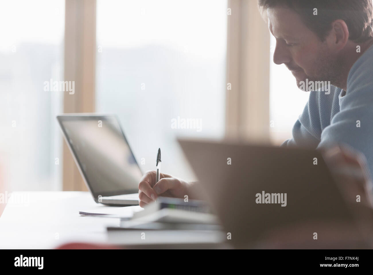 Focused businessman taking notes in meeting Stock Photo