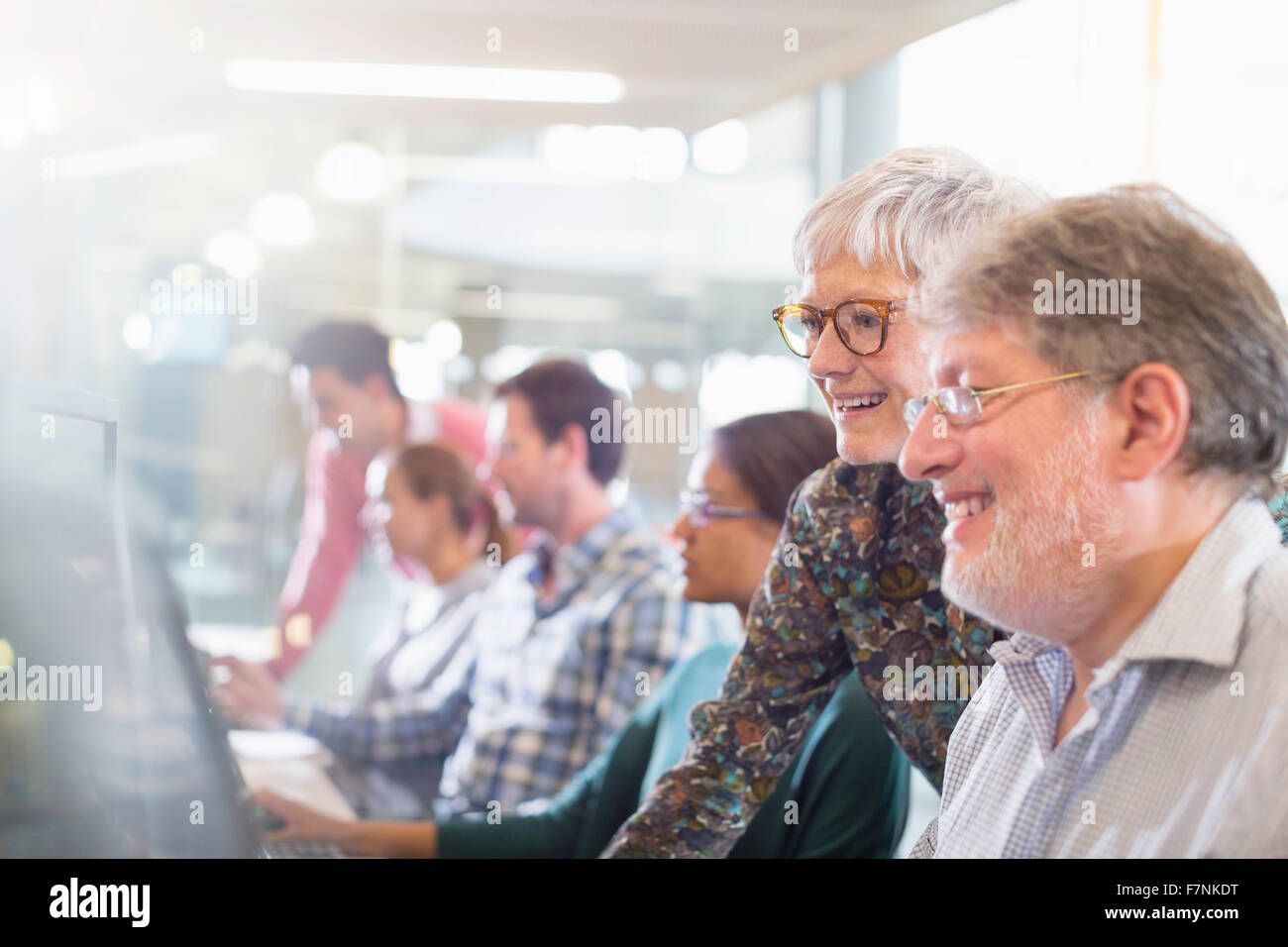 Students at computer in adult education classroom Stock Photo - Alamy