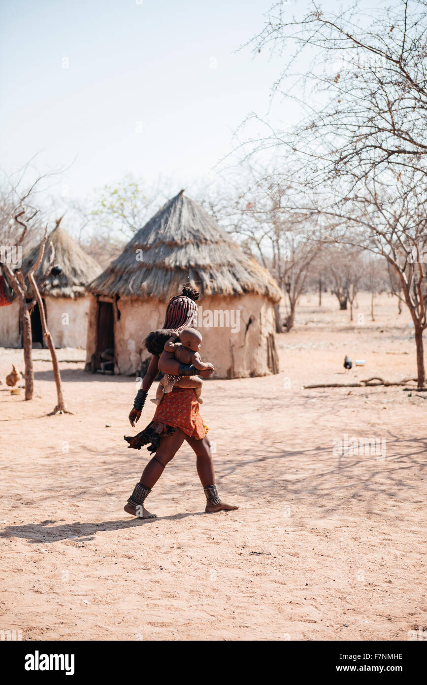Namibia, Damaraland, young woman with her baby in a Himba village Stock Photo