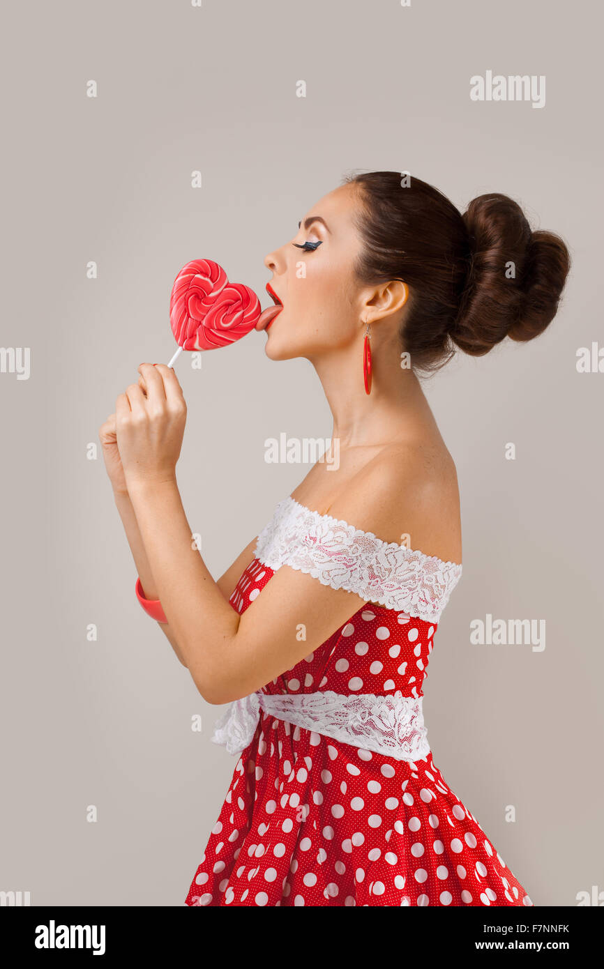 Happy Woman Lick Red Lollipop. Pin-up retro style Stock Photo - Alamy