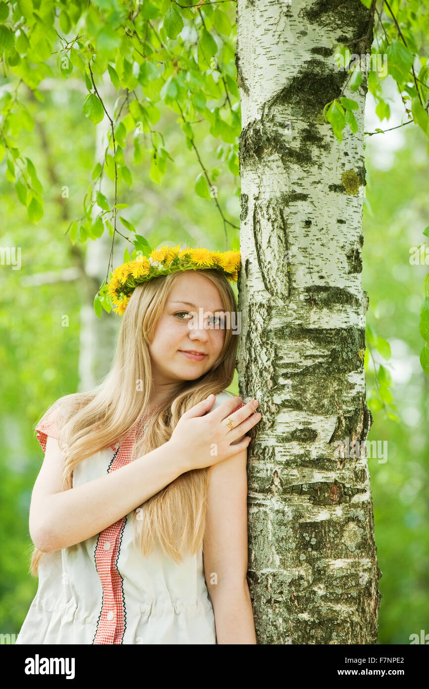 Portrait of beauty girl in dandelion wreath near birch Stock Photo - Alamy