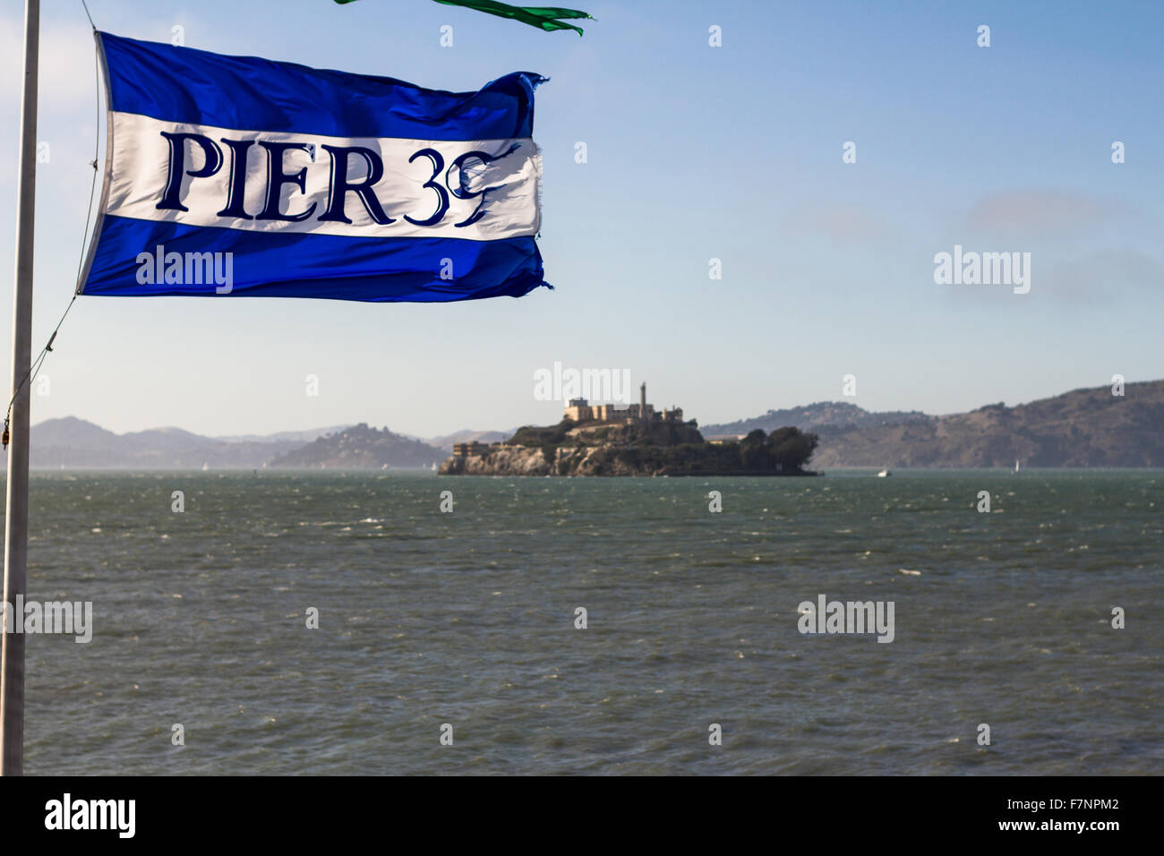 Pier 39 flag with view on Alcatraz Island, San Francisco Stock Photo