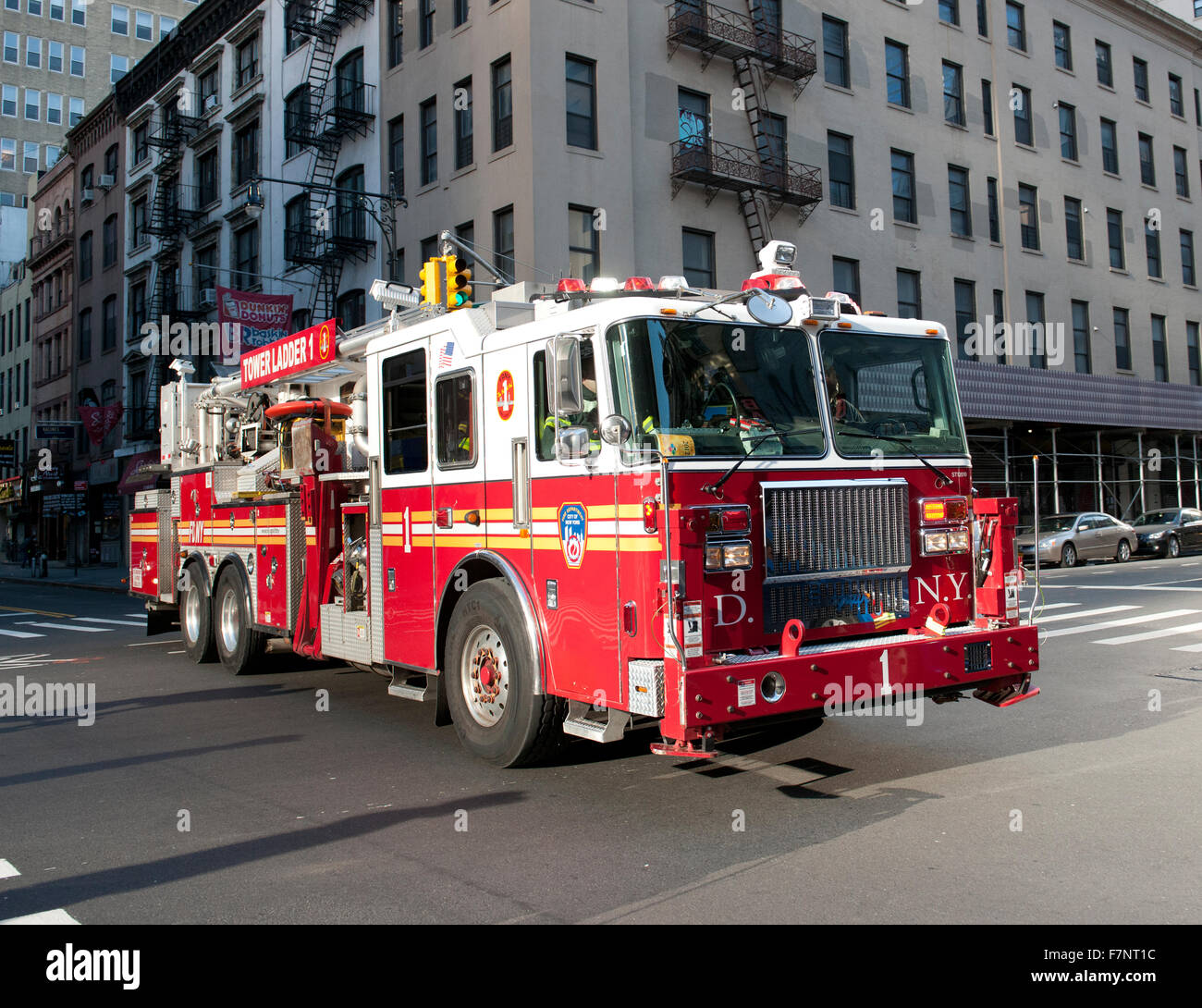 Tower Ladder No1 fire truck  answering an emergency call, Manhattan, New York City, New York, USA. Stock Photo