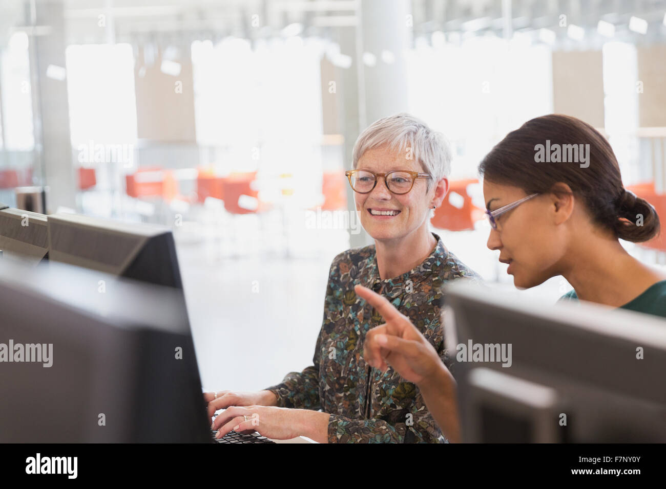 Women working at computers in adult education classroom Stock Photo