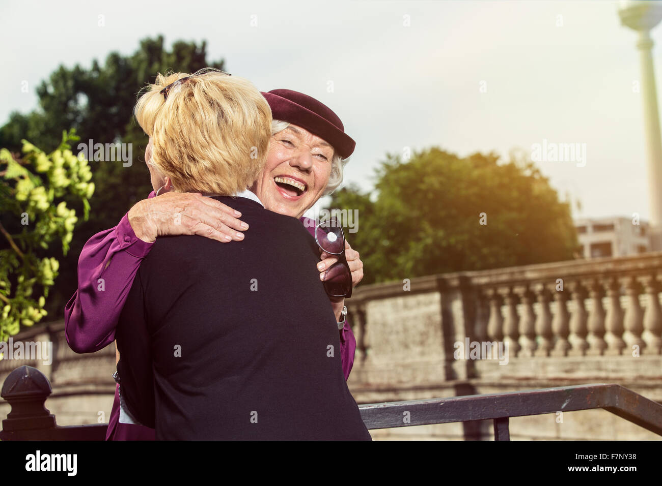 Germany, Berlin, portrait of two happy senior women hugging each other Stock Photo