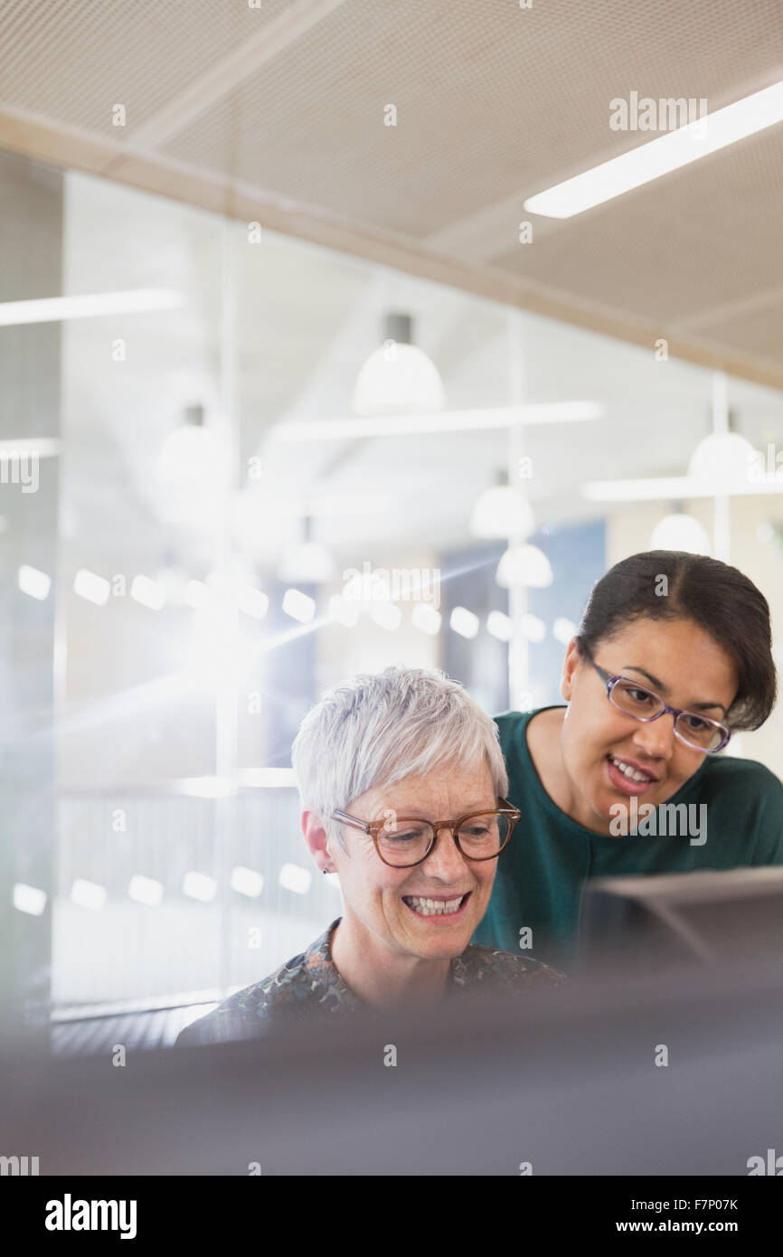 Businesswomen at computer in adult education classroom Stock Photo