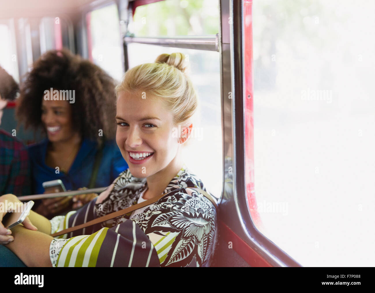 Portrait smiling blonde woman riding bus Stock Photo
