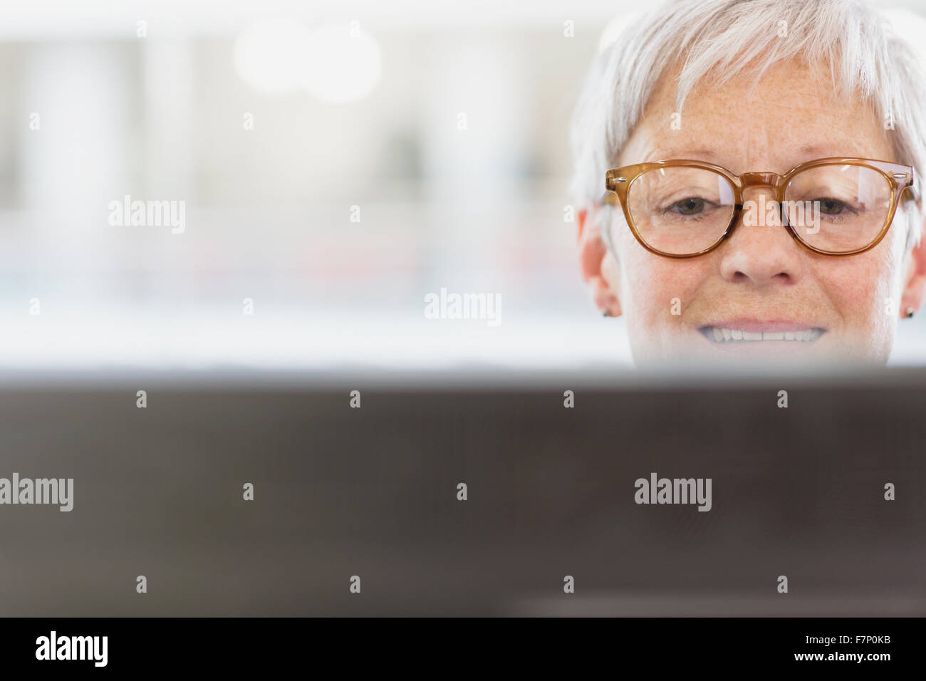 Senior businesswoman with eyeglasses using computer Stock Photo