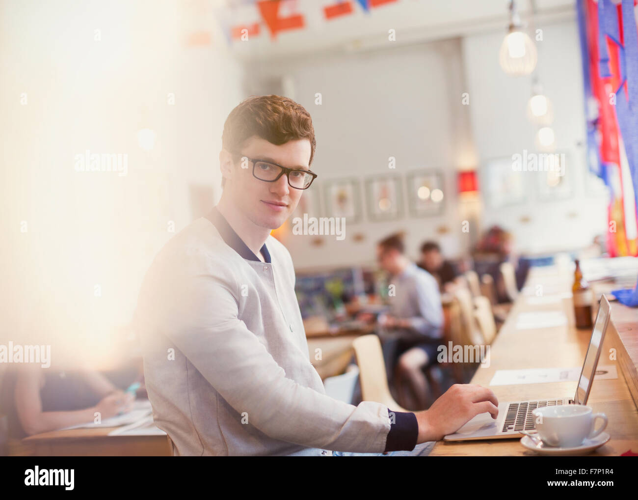 Portrait man using laptop in cafe Stock Photo