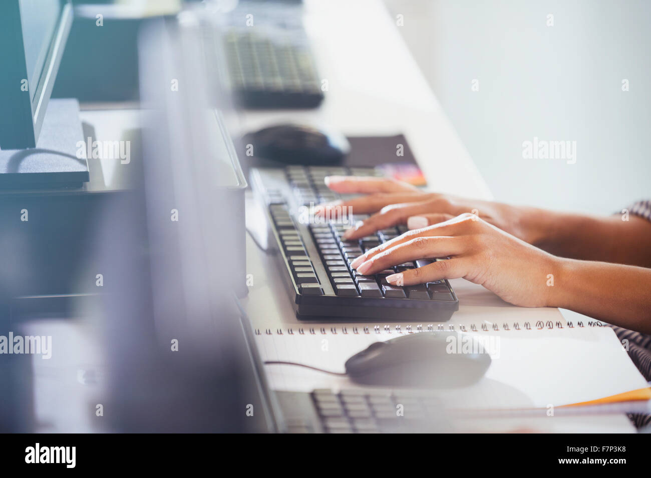 Student typing on computer keyboard in adult education classroom Stock Photo