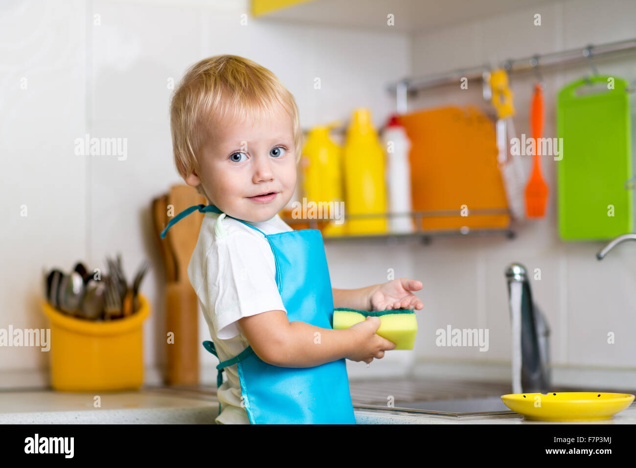 Little boy washing dishes Stock Photo