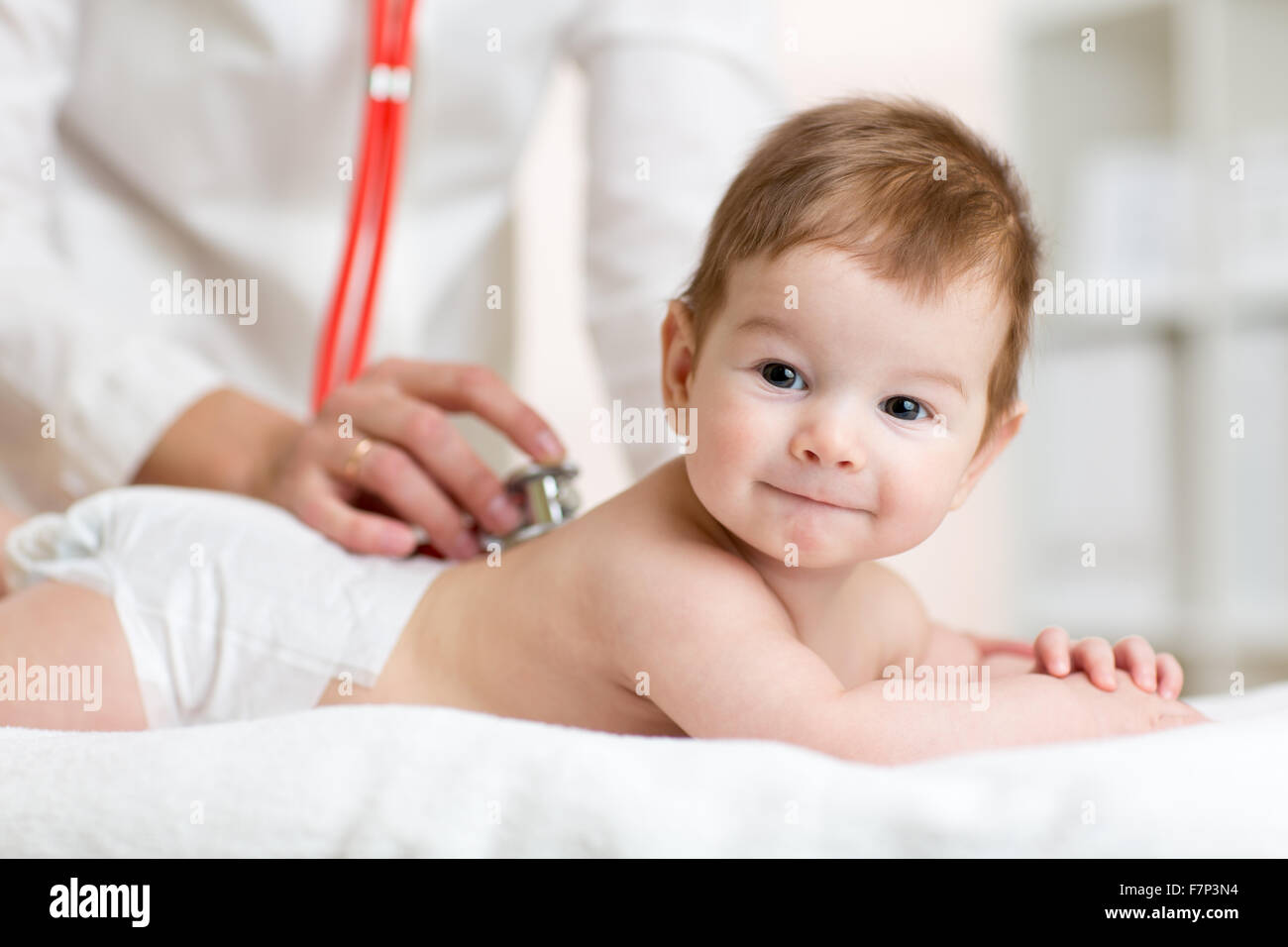 Baby health care. Doctor examining child Stock Photo Alamy