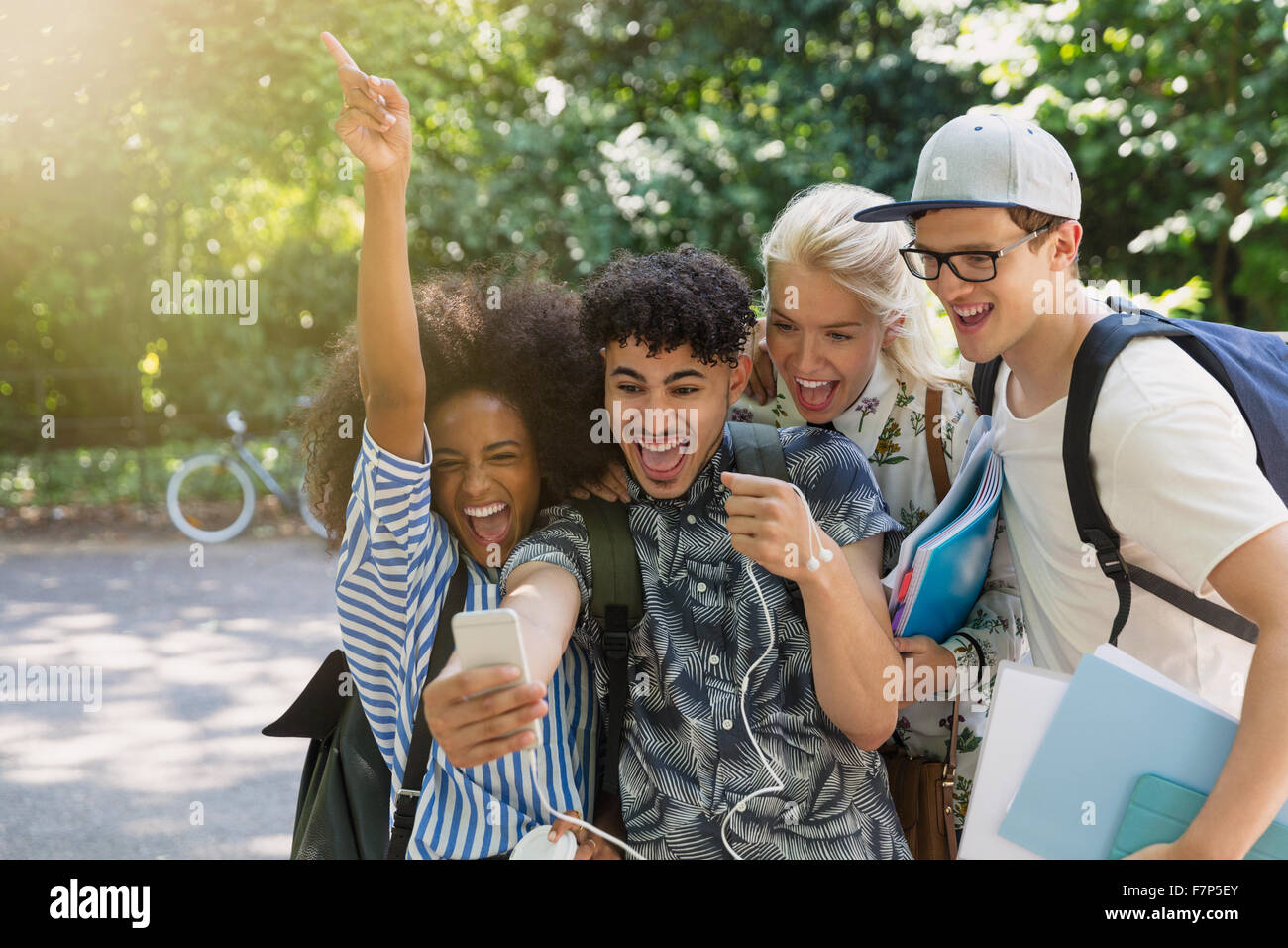 Enthusiastic college students taking selfie in park Stock Photo - Alamy