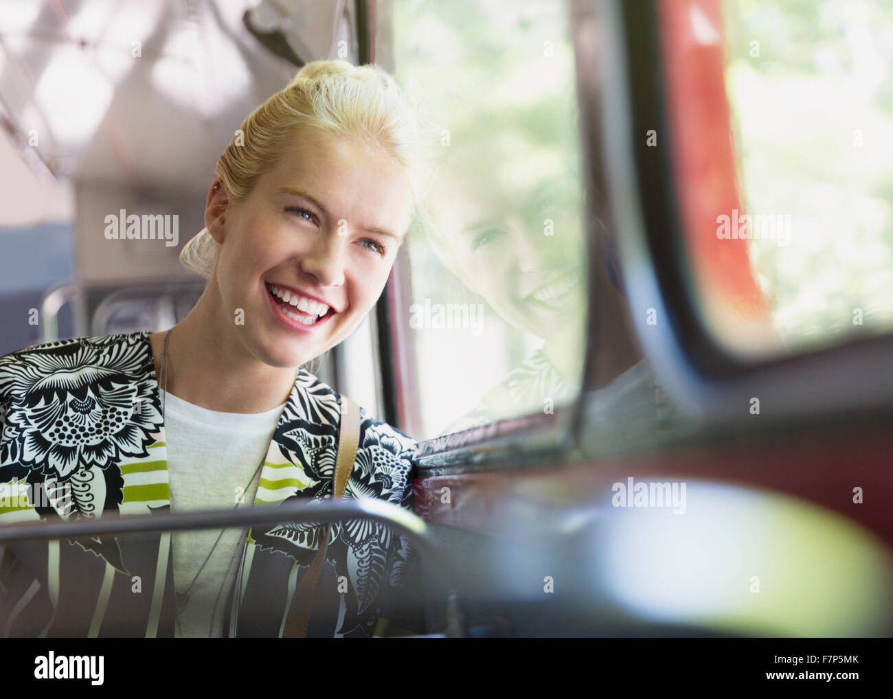 Enthusiastic woman riding bus Stock Photo